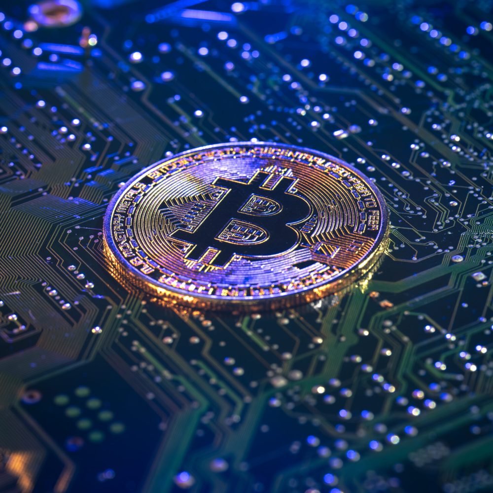 Bitcoin coin close-up on circuit board. Finance concept. High quality photo